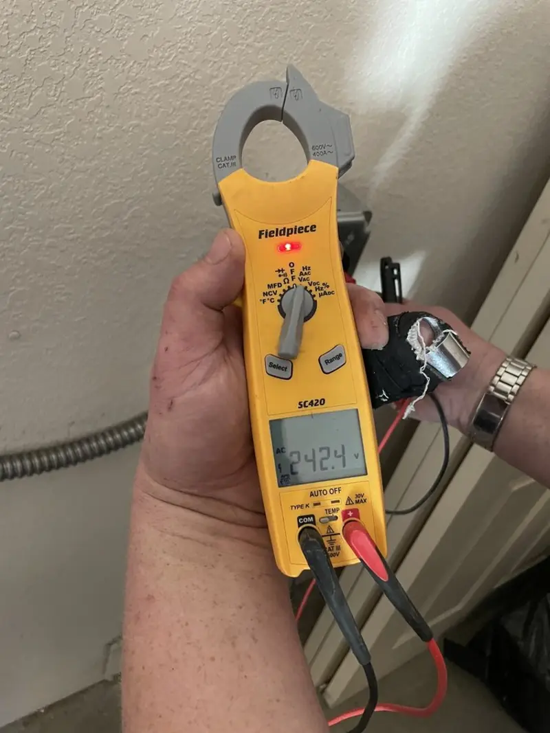 Voltage testing with clamp meter during Electrical Installation Services in Walton